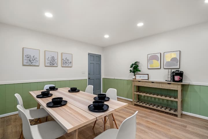 Upgrade your dining room with Above All Handyman. This image features a beautifully renovated dining space with classic wainscoting and a stylish chair rail.